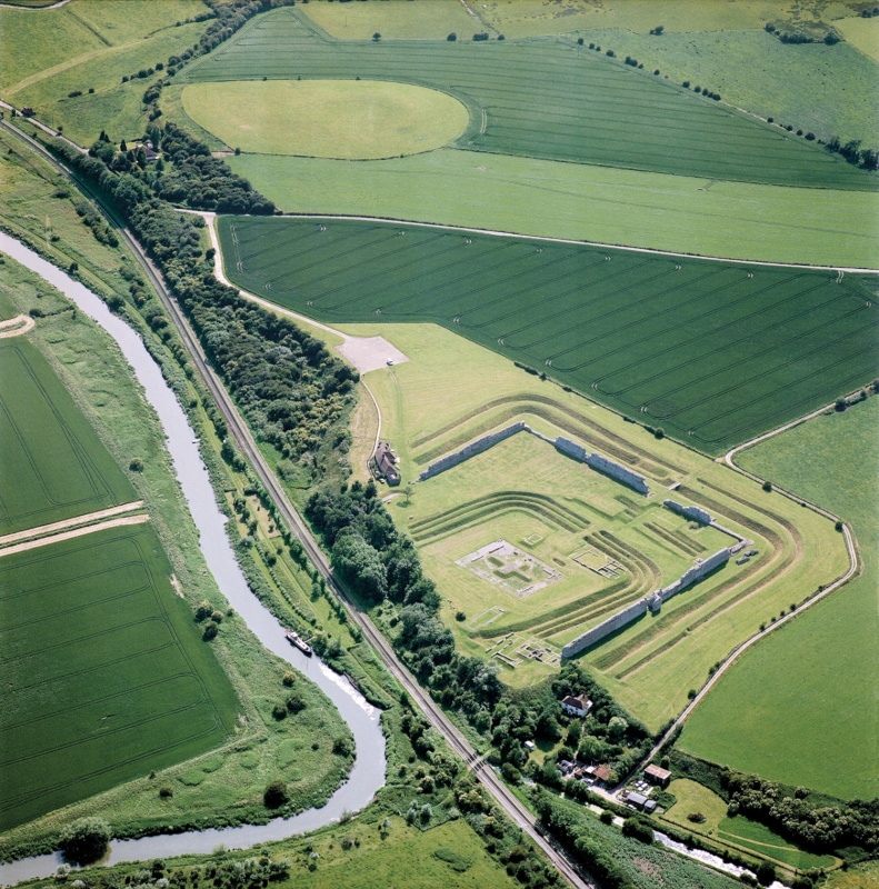 Figure 2: Aerial view of Richborough, from the north, showing the whole area of the early port town. The oval area in the background is the amphitheatre site.