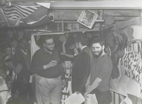 Fig. 8. Adrian Henri, Roger McGough and Pete Brown (with Mike McCartney in the audience, left), during City event, Liverpool, 1962.