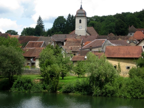 Figure 2: Clerval’s bell tower, the “People”’s house in the foreground, along the Doubs river (July 2017)
